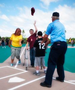 2 boys at home base with umpire