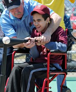 Boy in wheelchair batting