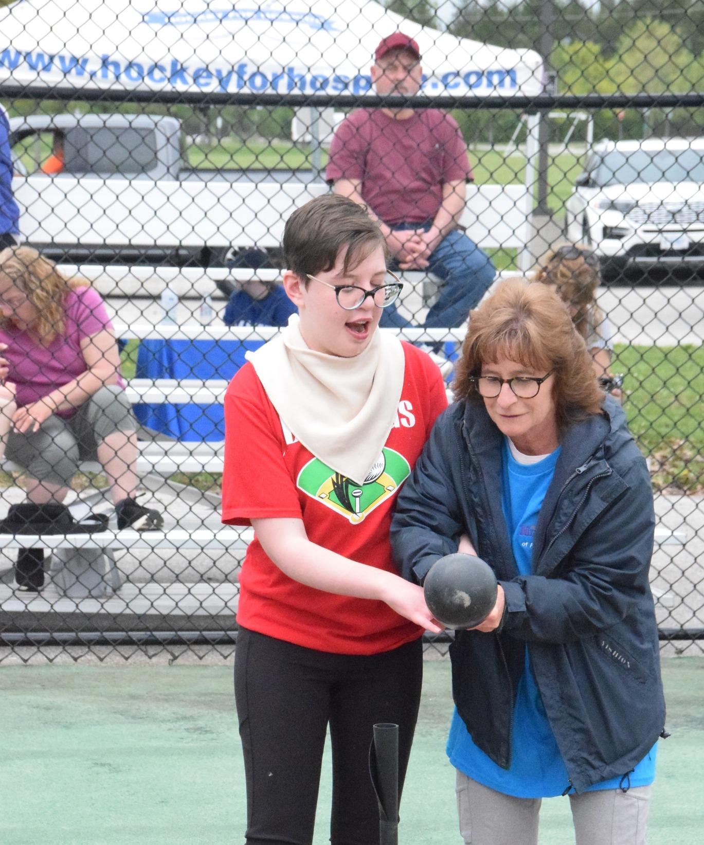 Man in wheelchair throwing baseball